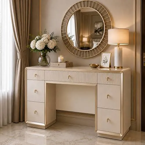 Cream twin-pedestal dressing table with a fluted top drawer and metallic-tone handles, styled beneath a round wall mirror